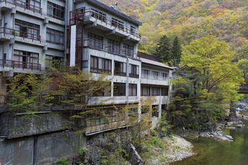 Abandoned hot spring ryokan by a mountain river in Japan