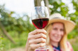 Blond woman holding a glass of red wine