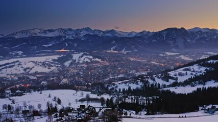 Wall Mural - Snowy zakopane after sunset in winter, aerial view