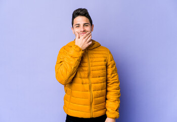 Young caucasian man isolated on purple background doubting between two options.