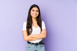 © Asier - Young indian woman isolated on purple background who feels confident, crossing arms with determination.