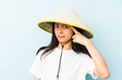 © Asier - Young chinese woman wearing a vietnamese hay isolated pointing with finger at you as if inviting come closer.