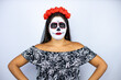 © Irene - Woman wearing day of the dead costume over isolated white background skeptic and nervous, disapproving expression on face with arms in waist