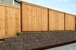Wood Fence on Stone Retaining Wall on Side of Home