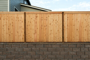 Wood Fenceing over Stone Retaining Wall