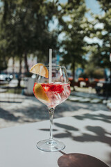 Wall Mural - Closeup shot of a glass of cocktail with lemon slices and strawberries