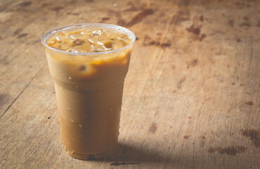 Wall Mural - latte with ice on wooden table