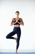 © zamuruev - Sporty young woman doing yoga practice isolated on white background, concept of healthy life and natural balance between body and mental development.