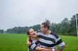 © Ivo de Bruijn/Stocksy - Two female rugby teammates hugging and looking at eachother.