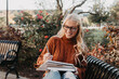 © Chelsea Victoria/Stocksy - A young woman studying at a college campus