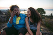 © Rob and Julia Campbell/Stocksy - Mother and daughter hiking together at sunset.