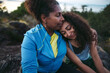 © Rob and Julia Campbell/Stocksy - Mother and daughter hiking together at sunset.