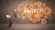 © ra2 studio - Businessman defending with umbrella from FINTECH inscription, technology concept
