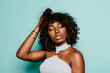 © MyMicrostock/Stocksy - Portrait of sexy black woman over light blue background