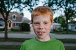 © Gabriel (Gabi) Bucataru/Stocksy - Smiling redhead boy on a street