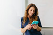 © MyMicrostock/Stocksy - Calm dentist browsing cellphone at work space