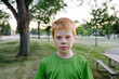 © Gabriel (Gabi) Bucataru/Stocksy - Redhead boy in a park at sunset