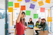 © MyMicrostock/Stocksy - Woman writing on notes sharing ideas with colleagues