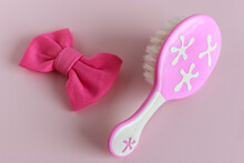 Pink Comb With White Brush And Pink Fabric Buckle For Children On Isolated Pink Background