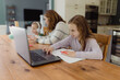© Jakob Lagerstedt/Stocksy - Mother helping her young boy and daughter with school work