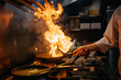 © Sergio Marcos/Stocksy - Crop chef cooking a WOK on gas stove