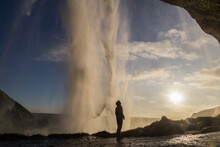 Person In Silhouette Looking At The Seljalandsfoss Waterfall In Iceland