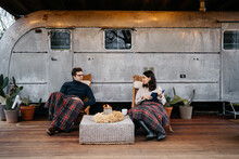 Adult Couple Enjoying Time Together At The Porch Of A Travel Trailer