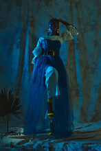 Photo Of A Black Girl Standing In A Fashionable Outfit In The Blue Light At The Studio