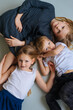 © Ivan Ozerov/Stocksy - three children lie beautifully on the floor