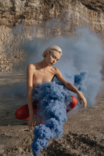Naked Girl In Red Tights In Blue Smoke From A Smoke Bomb