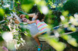 © JImena Roquero/Stocksy - Father an daughter on hammock