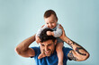 © Sergio Marcos/Stocksy - Dad with his baby on his shoulders at home