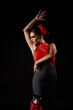 © Faustino Carmona/ADDICTIVE STOCK - Seductive young Hispanic female in traditional red costume performing sensual Flamenco dance and looking down