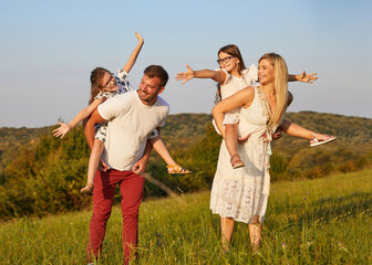 child family outdoor mother woman father girl happy happiness lifestyle having fun bonding piggyback