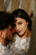 © Jake Jakab/ADDICTIVE STOCK - High angle of sensual newlywed couple in stylish clothing cuddling gently while standing on wooden bridge looking at camera