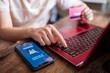 © Juan Alberto Ruiz/ADDICTIVE STOCK - Female sitting at table at home and making payment for online purchases for food via mobile app