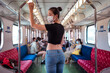 © Juan Alberto Ruiz/ADDICTIVE STOCK - Side view of ethnic female wearing protective mask traveling by train during coronavirus outbreak