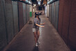 © Juan Alberto Ruiz/ADDICTIVE STOCK - Calm female standing on narrow shabby street and experiencing virtual reality while wearing wireless VR goggles