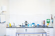 © Alvaro Sanchez/ADDICTIVE STOCK - Clean table located near cupboards with medical equipment inside office of contemporary veterinary clinic