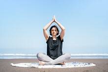 Full Body Young Female In Sportswear Doing Meditation While Practicing Yoga On Sandy Seashore