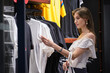 © Luis Gomez/ADDICTIVE STOCK - Pretty woman looking at clothes in a store