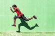 © Sergio Victor Vega/ADDICTIVE STOCK - Side view of black sportsman in activewear in moment of jumping during intense workout on sunny day