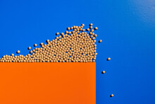 Top View Of Grain Representing Crowd Of People Falling From Edge Of Cliff Made Of Orange Paper And Demonstrating Concept Of Herd Instinct Of Human Beings