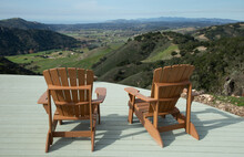 Wooden Adirondack Chairs On The Terrace With A Spectacular View Of The Country Side And The Pacific Ocean