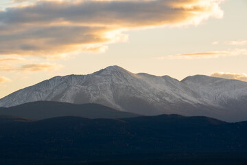 Hazy fall afternoon sunset shot in Yukon Territory, northern Canada taken in the fall/autumn time of year with a huge mountains in the shot and snow capped peaks in the distance. 