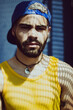 © Erika Astrid/Stocksy - Man in yellow mesh tank