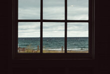 View Of A Wavy Lake Through A Window Frame