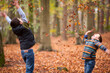 © Lee Avison Photography/Stocksy - two boys throwing autumn leaves