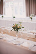 © Jess Craven/Stocksy - Simple burlap and white table setting for wedding or event