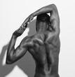 © Javier DÔøΩ_ez/Stocksy - Muscular back of young man stretching arms